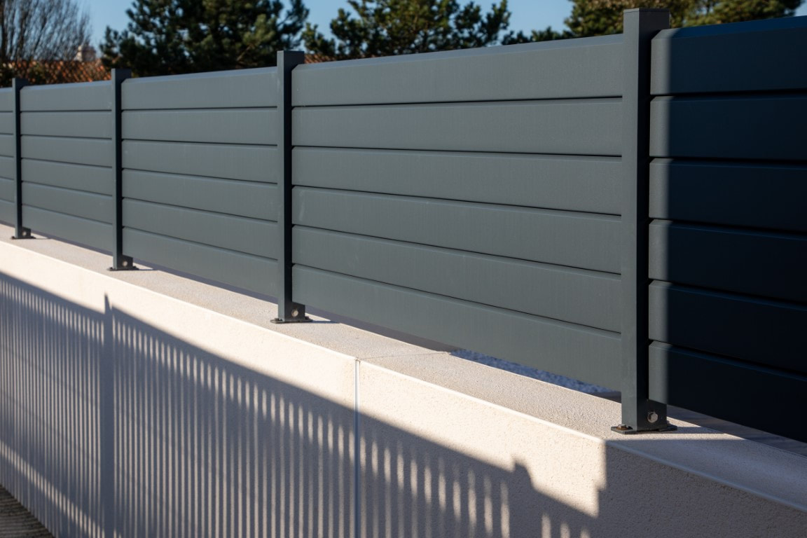 An image of a aluminum grey fence installed by a fence contractor