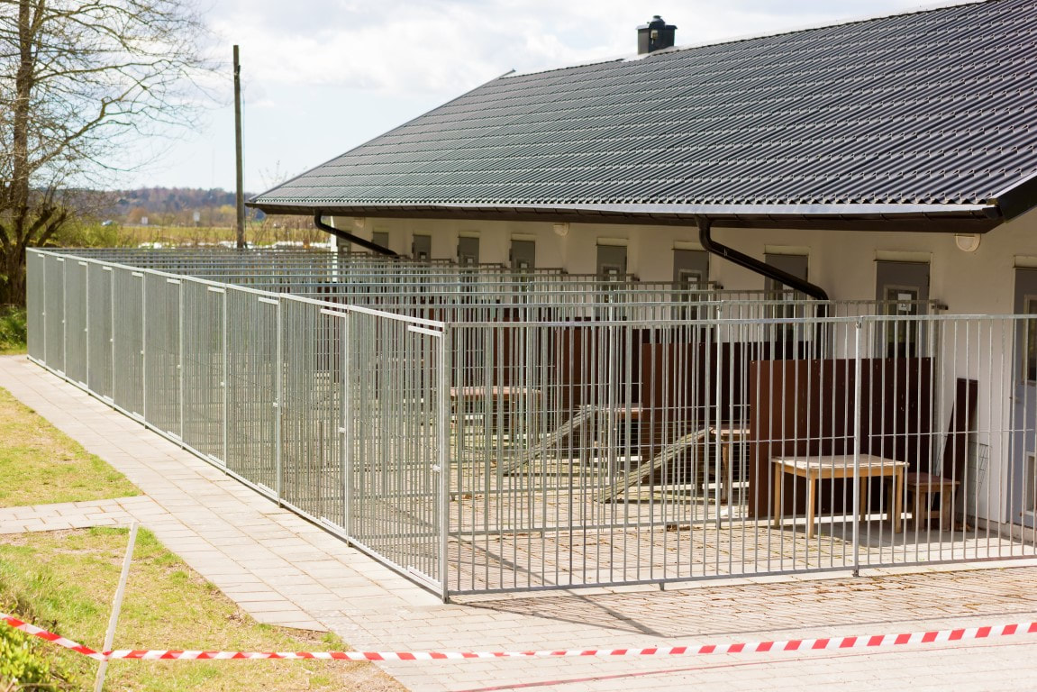 An image of a white metal fence installed by a fence company